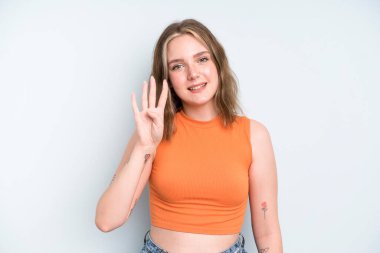 caucasian pretty woman smiling and looking friendly, showing number four or fourth with hand forward, counting down