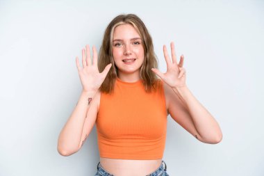 caucasian pretty woman smiling and looking friendly, showing number nine or ninth with hand forward, counting down