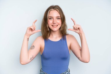 caucasian pretty woman framing or outlining own smile with both hands, looking positive and happy, wellness concept