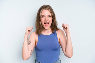caucasian pretty woman feeling happy, surprised and proud, shouting and celebrating success with a big smile