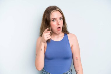 caucasian pretty woman pointing at camera with an angry aggressive expression looking like a furious, crazy boss