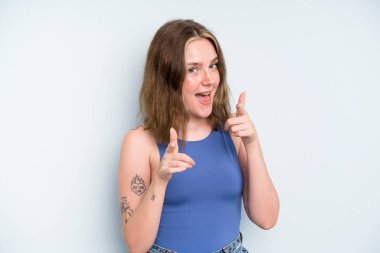 caucasian pretty woman smiling with a positive, successful, happy attitude pointing to the camera, making gun sign with hands