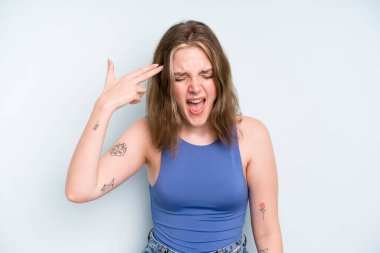 caucasian pretty woman looking unhappy and stressed, suicide gesture making gun sign with hand, pointing to head