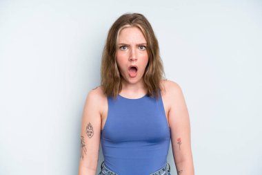 caucasian pretty woman feeling terrified and shocked, with mouth wide open in surprise