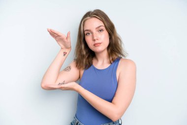 caucasian pretty woman holding an object with both hands on side copy space, showing, offering or advertising an object
