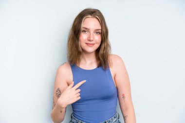 caucasian pretty woman looking proud, confident and happy, smiling and pointing to self or making number one sign