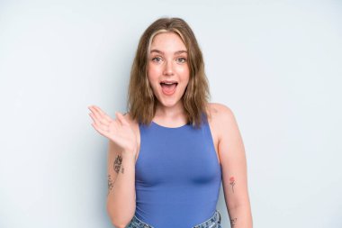 caucasian pretty woman feeling happy, surprised and cheerful, smiling with positive attitude, realizing a solution or idea