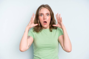 caucasian pretty woman screaming with hands up in the air, feeling furious, frustrated, stressed and upset