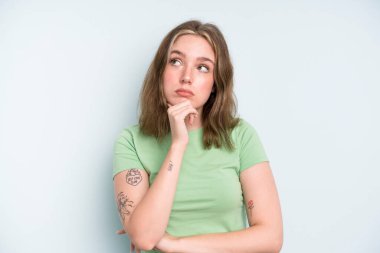 caucasian pretty woman thinking, feeling doubtful and confused, with different options, wondering which decision to make