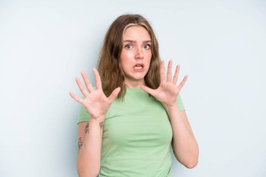 caucasian pretty woman feeling terrified, backing off and screaming in horror and panic, reacting to a nightmare