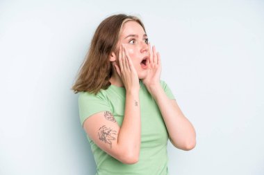 caucasian pretty woman feeling happy, excited and surprised, looking to the side with both hands on face