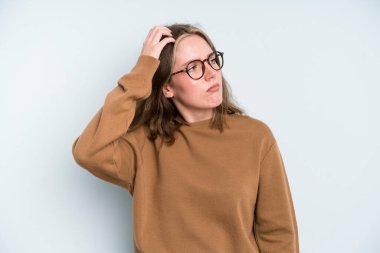 caucasian pretty woman feeling puzzled and confused, scratching head and looking to the side