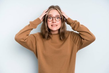 caucasian pretty woman feeling stressed, worried, anxious or scared, with hands on head, panicking at mistake