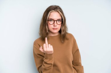 caucasian pretty woman feeling angry, annoyed, rebellious and aggressive, flipping the middle finger, fighting back