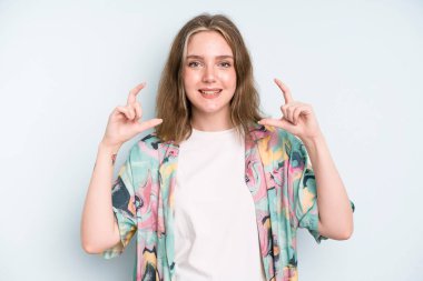 caucasian pretty woman framing or outlining own smile with both hands, looking positive and happy, wellness concept