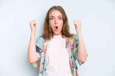 caucasian pretty woman celebrating an unbelievable success like a winner, looking excited and happy saying take that!