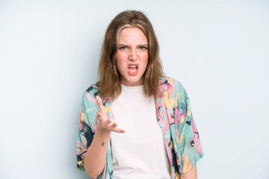 caucasian pretty woman looking angry, annoyed and frustrated screaming wtf or whats wrong with you 