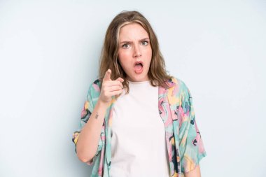 caucasian pretty woman pointing at camera with an angry aggressive expression looking like a furious, crazy boss