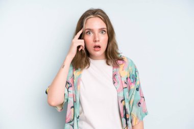 caucasian pretty woman looking surprised, open-mouthed, shocked, realizing a new thought, idea or concept