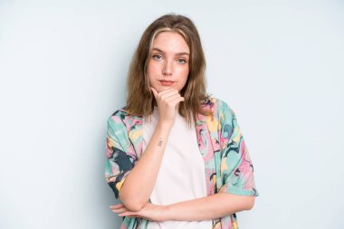 caucasian pretty woman looking serious, confused, uncertain and thoughtful, doubting among options or choices