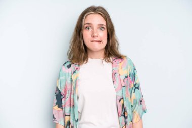 caucasian pretty woman looking puzzled and confused, biting lip with a nervous gesture, not knowing the answer to the problem