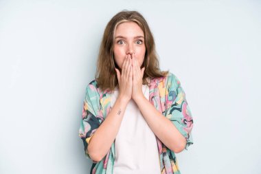 caucasian pretty woman happy and excited, surprised and amazed covering mouth with hands, giggling with a cute expression