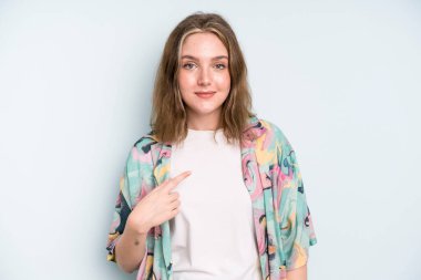 caucasian pretty woman looking proud, confident and happy, smiling and pointing to self or making number one sign