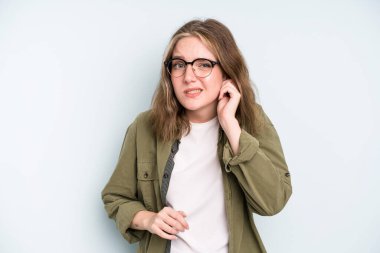 caucasian pretty woman feeling stressed, frustrated and tired, rubbing painful neck, with a worried, troubled look