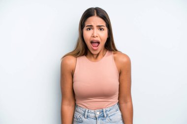 hispanic latin pretty woman feeling terrified and shocked, with mouth wide open in surprise