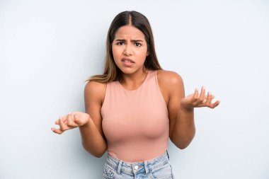 hispanic latin pretty woman feeling clueless and confused, not sure which choice or option to pick, wondering