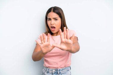 hispanic latin pretty woman feeling terrified, backing off and screaming in horror and panic, reacting to a nightmare