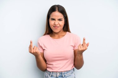 hispanic latin pretty woman feeling provocative, aggressive and obscene, flipping the middle finger, with a rebellious attitude