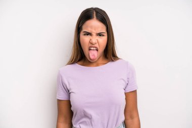hispanic latin pretty woman feeling disgusted and irritated, sticking tongue out, disliking something nasty and yucky