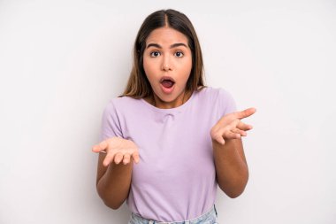 hispanic latin pretty woman feeling extremely shocked and surprised, anxious and panicking, with a stressed and horrified look