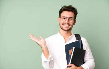 Bir çanta ve kitapla izole edilmiş genç yakışıklı bir adam. Üniversite öğrencisi konsepti