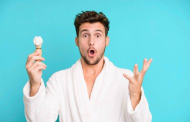 Yakışıklı genç kendini çok şaşırmış ve şaşkın hissediyor. Bornoz giyiyor ve tıraş oluyor.
