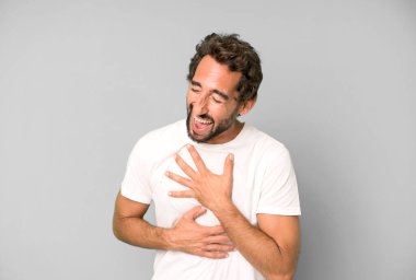 Genç çılgın adam komik bir şakaya gülüyor, mutlu ve neşeli hissediyor, eğleniyor.