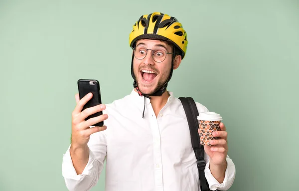 young handsome businessman isolated with a bike helmet