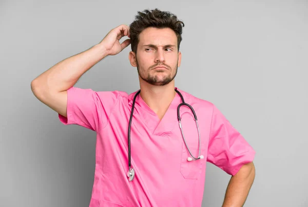 Handsome Teenager Feeling Puzzled Confused Scratching Head Nurse Concept — Stock Photo, Image