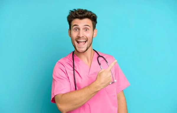 Handsome Teenager Looking Excited Surprised Pointing Side Nurse Concept — Stock Photo, Image