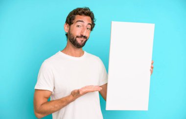 Genç, çılgın, sakallı ve etkileyici bir adam. Yanında fotokopi odası var.