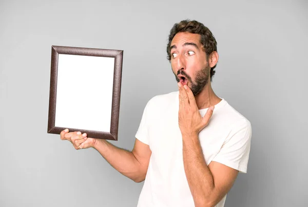 Young Crazy Bearded Expressive Man Holding White Empty Frame — Stock Photo, Image