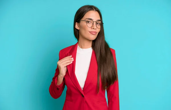 hispanic pretty woman looking arrogant, successful, positive and proud with red blazer. business concept
