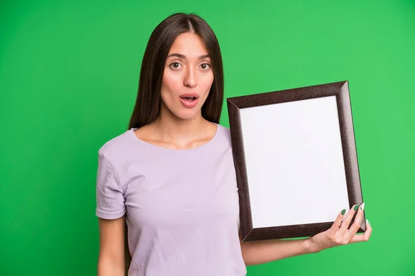 Young Pretty Woman Looking Very Shocked Surprised Empty Blank Picture — Stock Photo, Image
