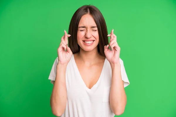 Mujer Bonita Hispana Sonriendo Ansiosamente Cruzando Ambos Dedos Sintiéndose Preocupada —  Fotos de Stock