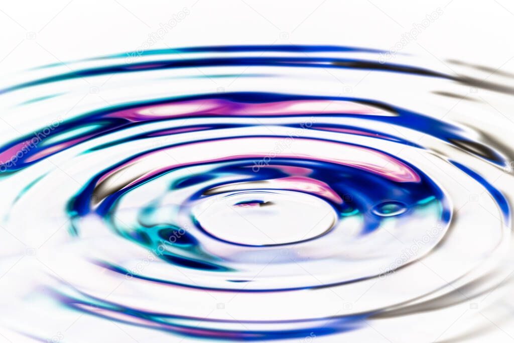Close up of colorful ripple circles on water surface