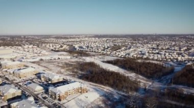 From flying in a snowy day towards downtown Lexington, Kentucky gradually turning the opposite direction for revealing development of new subdivisions in the neighboring county of Nicholasville