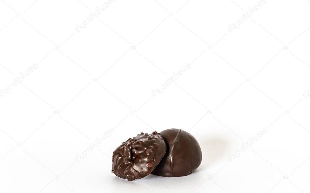 Two dark chocolate candies isolated on white background