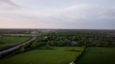 Lexington, Kentucky şehir merkezini uzaktan gözlemliyorum. Şehrin kenar mahallelerindeki tarım arazilerine hava manzarası giderek alçalıyor..