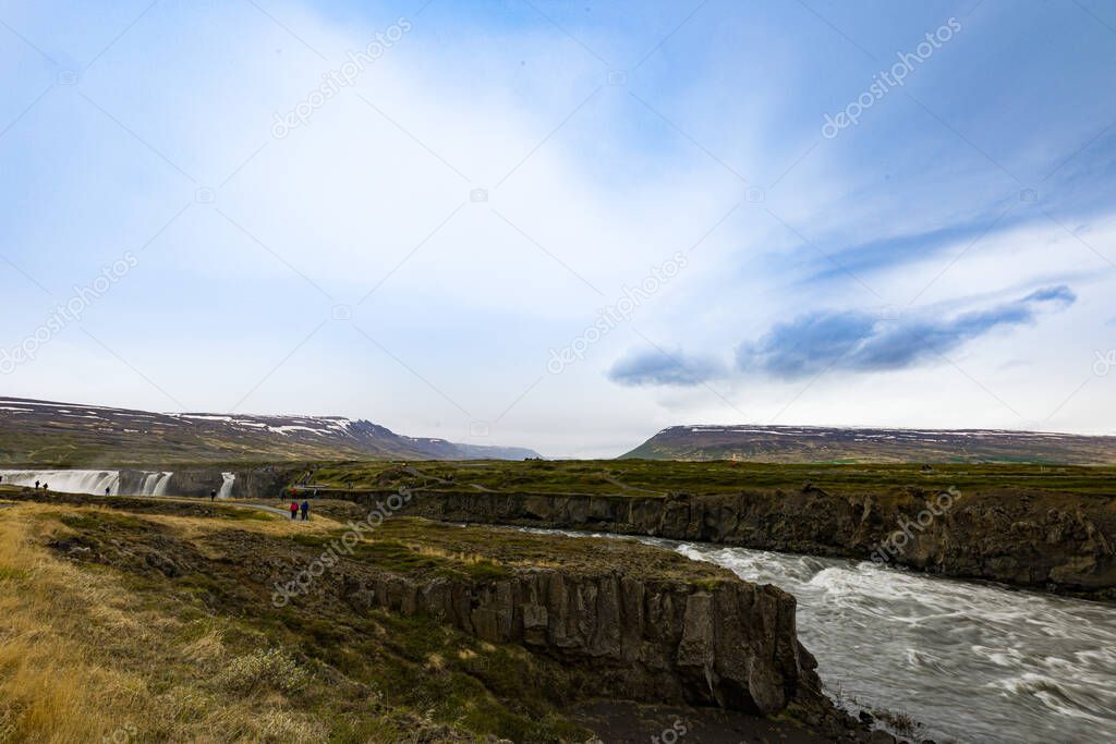 Stream of violent water flow coming out of Godafoss waterfalls in northern Iceland.
